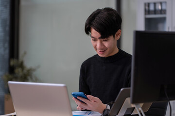 Businessman working at office overtime with laptop and documents on his desk, financial adviser analyzing data.