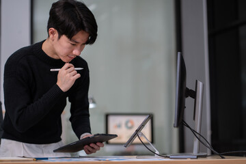 Businessman working at office overtime with laptop and documents on his desk, financial adviser...