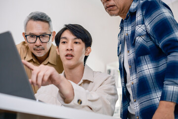 Group of asian senior in a collaborative software development analyzing  flowcharts  during a bootcamp training