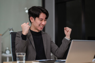Successful business man, excited young man Keeping up arms and showing positive emotions, happy...