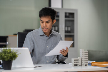 Buying a home or insurance deal, an insurance agent pointing a pen to those interested in renting a...