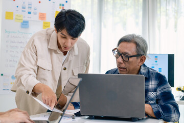 Group of asian senior in a collaborative software development analyzing  flowcharts  during a bootcamp training