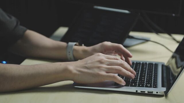 Young adult Asian female software developer coding program on desktop computer. Woman work from home, remote working, freelance programmer job, smart digital nomad lifestyle concept. Close Up