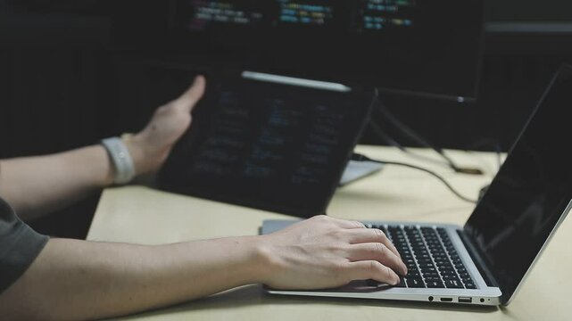 Young adult Asian female software developer coding program on desktop computer. Woman work from home, remote working, freelance programmer job, smart digital nomad lifestyle concept. Close Up