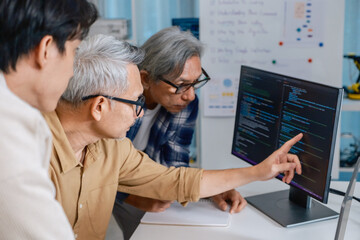Team of developers collaborating in brainstorming and coding project at office workspace