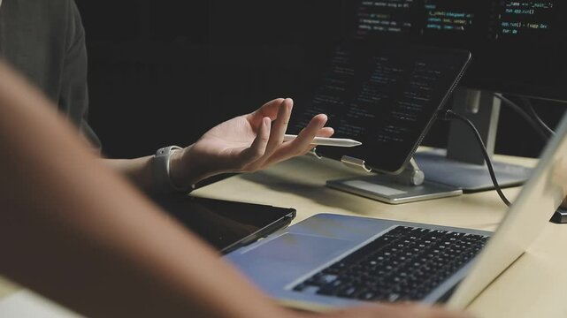 Young adult Asian female software developer coding program on desktop computer. Woman work from home, remote working, freelance programmer job, smart digital nomad lifestyle concept. Close Up