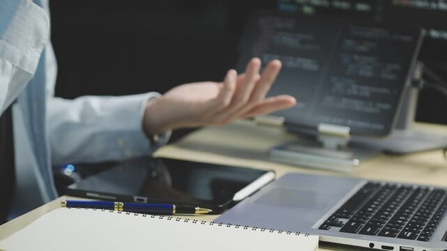 Young adult Asian female software developer coding program on desktop computer. Woman work from home, remote working, freelance programmer job, smart digital nomad lifestyle concept. Close Up