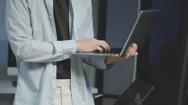 Young adult Asian female software developer coding program on desktop computer. Woman work from home, remote working, freelance programmer job, smart digital nomad lifestyle concept. Close Up