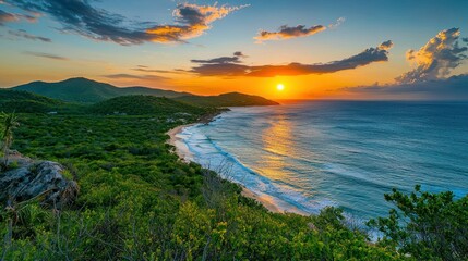 A breathtaking sunset over a lush green landscape with a calm ocean in the foreground and distant mountains in the background.