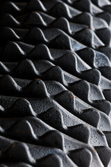 Fototapeta premium Industrial pattern, closeup of black metallic harrow disks with teeth for soil grinding