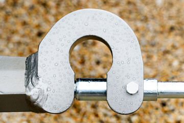 Metallic machine part with hydraulics, raindrops pattern covering metal