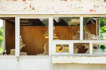 Broken glass windows on old abandoned urban kiosk