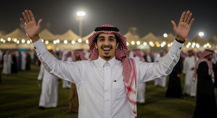 Joyful Saudi Man Waves at Night Festival