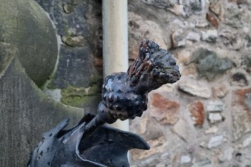 Rustic Metal Rose Sculpture Against Weathered Stone Wall