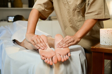 Foot spa massage treatment by professional massage therapist in luxury spa resort