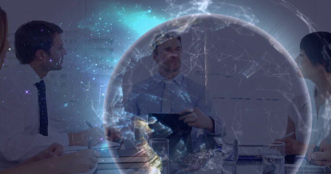 Image of illuminated globe rotating over multiracial colleagues brainstorming in meeting