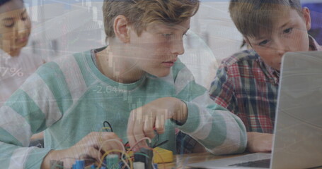 Image of caucasian students studying in classroom using laptop over globe and graph