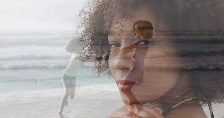 Image of thoughtful african american woman and african american mother and daughter dancing by sea © vectorfusionart