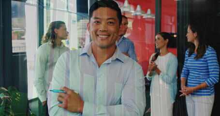 Image of statistical data processing over portrait of asian man smiling at office