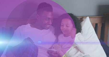 Image of purple circles over african american man and his daughter reading book together