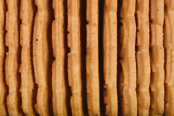 A stack of rectangular, light brown biscuits with ridged edges