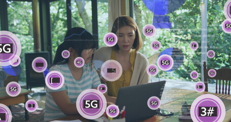 Image of 5g over asian mother and daughter using laptop