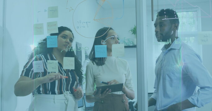 Image of flared light over multiracial coworkers brainstorming ideas over adhesive notes on wall