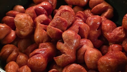 Fried cocktail sausages with glossy texture
