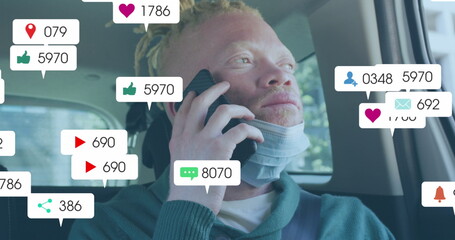 Image of social media icons with growing numbers over albino african american man