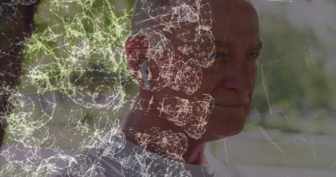 Image of blue hexagon pattern over connecting dots, caucasian mature man using wireless earbuds - Powered by Adobe