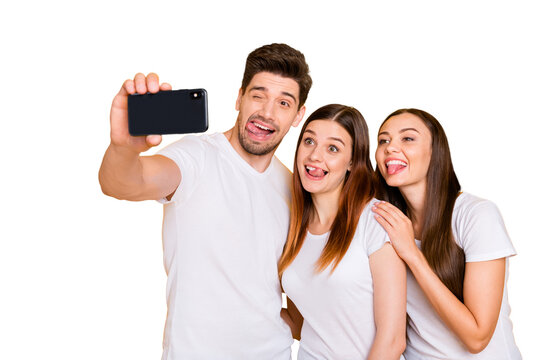 Portrait of three nice attractive lovely charming cheerful cheery playful comic childish person taking making selfie having fun fooling isolated over bright vivid shine yellow background - Powered by Adobe