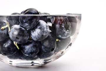 Fresh ripe whole blueberries on white background wooden in glass bowl blue berry