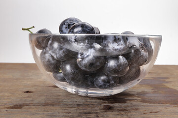 Fresh ripe whole blueberries on rustic wood background wooden in glass bowl blue berry