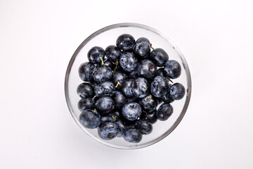 Fresh ripe whole blueberries on white background wooden in glass bowl blue berry
