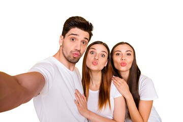 Self-portrait of three nice attractive lovely lovable charming cheerful cheery positive person sending you kiss having fun isolated over bright vivid shine yellow background
