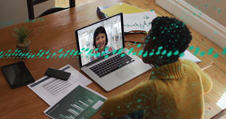 Image of online using laptop and smiling unk using laptop