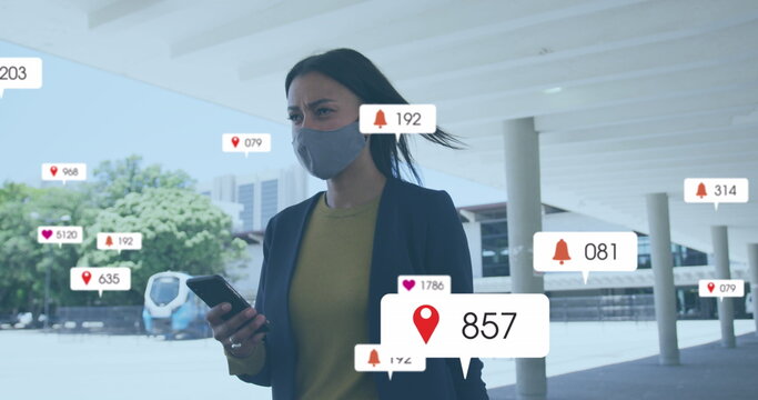 Image of multiple social media icons over woman in face mask outdoors