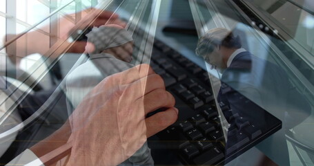 Image of hands using computer over diverse business people in office