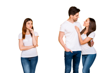 Portrait of pensive girl with foxy ginger hair looking at couple cuddling wearing white t-shirt isolated over yellow background