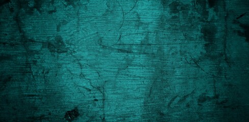  A textured background featuring a deep teal color with a distressed, grunge appearance. The surface shows variations in tone and subtle patterns, creating an abstract and moody aesthetic.
