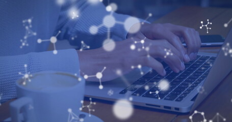 Image of molecules over caucasian man using laptop