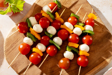 Fresh caprese skewers with cherry tomatoes, mozzarella balls, and bell pepper