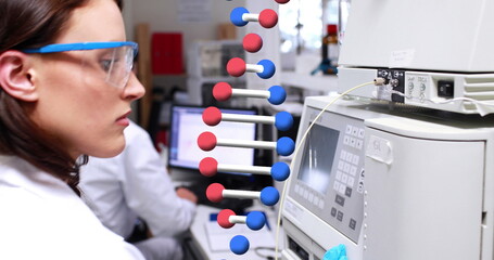 Image of dna strand over diverse doctors in lab