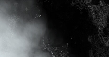 Image of grey cloud and white lightning flashes in night sky