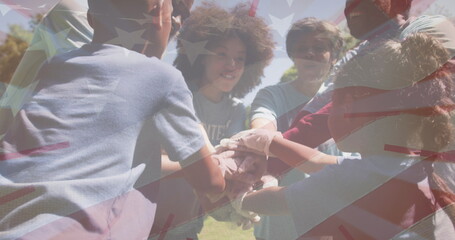 Image of flag of usa over diverse volunteers teaming up