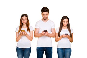 Portrait of three nice-looking attractive lovely focused concentrated person using device browsing...