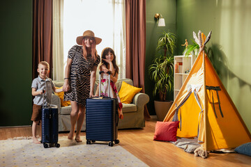 Family with suitcases getting ready for vacation at home