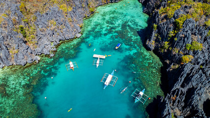 Aerial view of a beautiful tropical island with crystal clear water  with limestone cliffs  as the beach, Coron, Palawan, Philippines.
