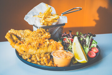 Beer Battered Snapper Fish made with crimson snapper, mesclun salad, fries