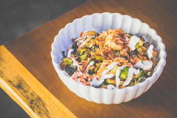 Burnt Brussels Sprouts with Char, Cream, and Umami Honey miso glaze, sour cream, fried shallots, chives